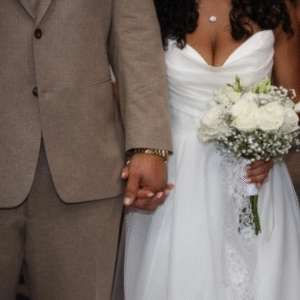 Couples helding hands during wedding.